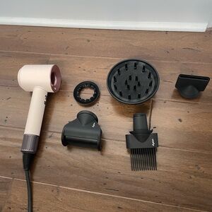 Selling brandy new dyson super sonic blow dryer in pink.